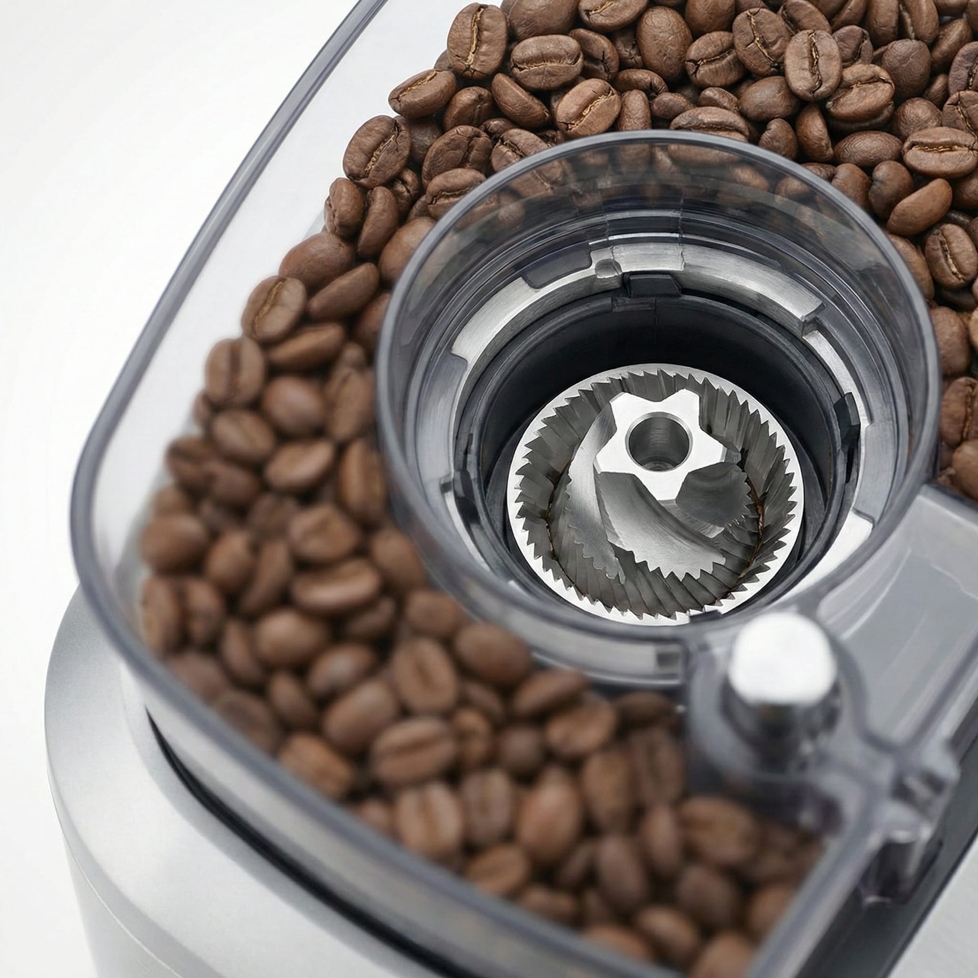 Close-up conical burr grinder mechanism freshly grinding whole coffee beans inside Breville Grind Control bean to cup automatic grind and brew system