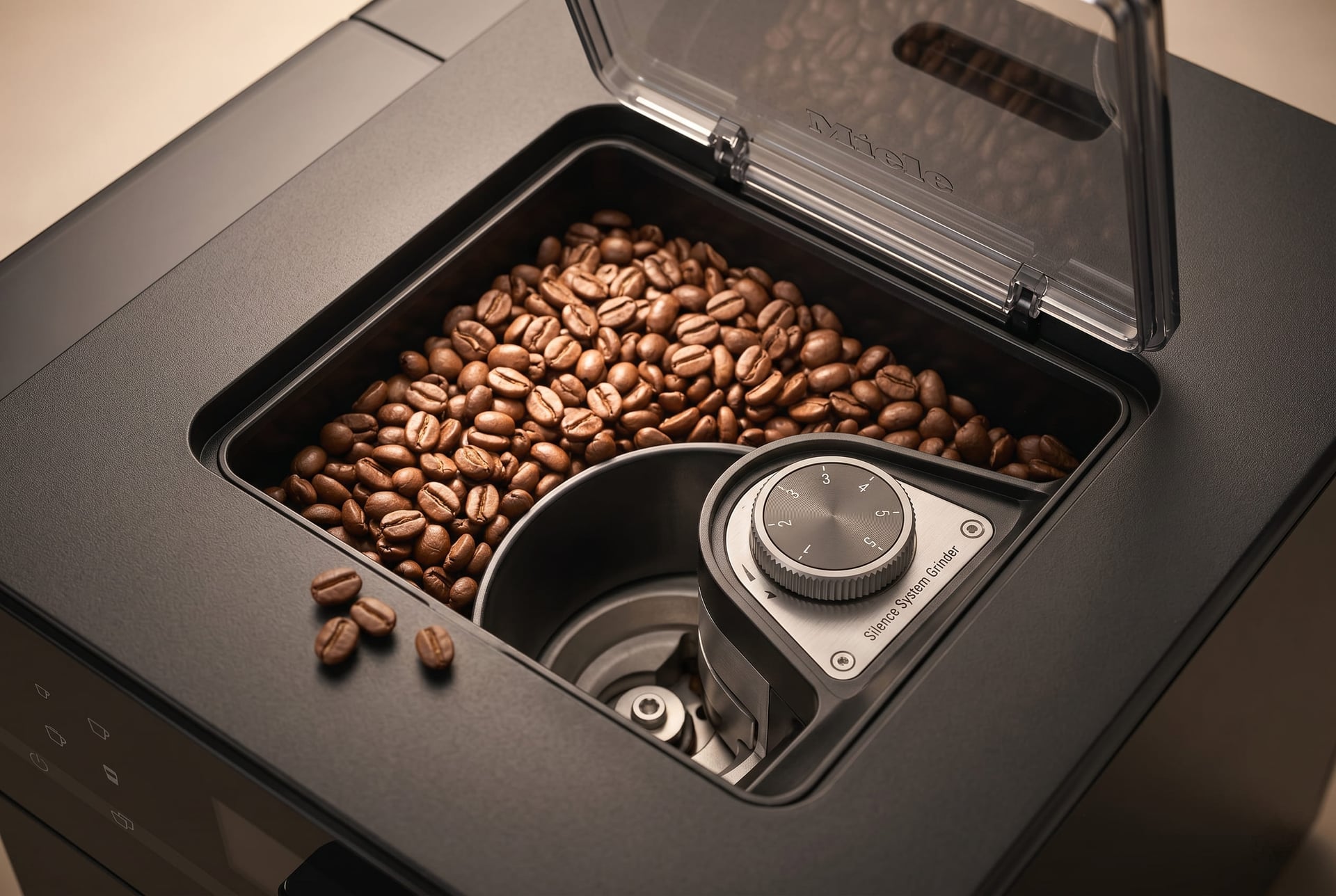 Miele CM 5310 Silence integrated ceramic flat burr grinder with 5-level grind settings freshly grinding whole coffee beans before brewing