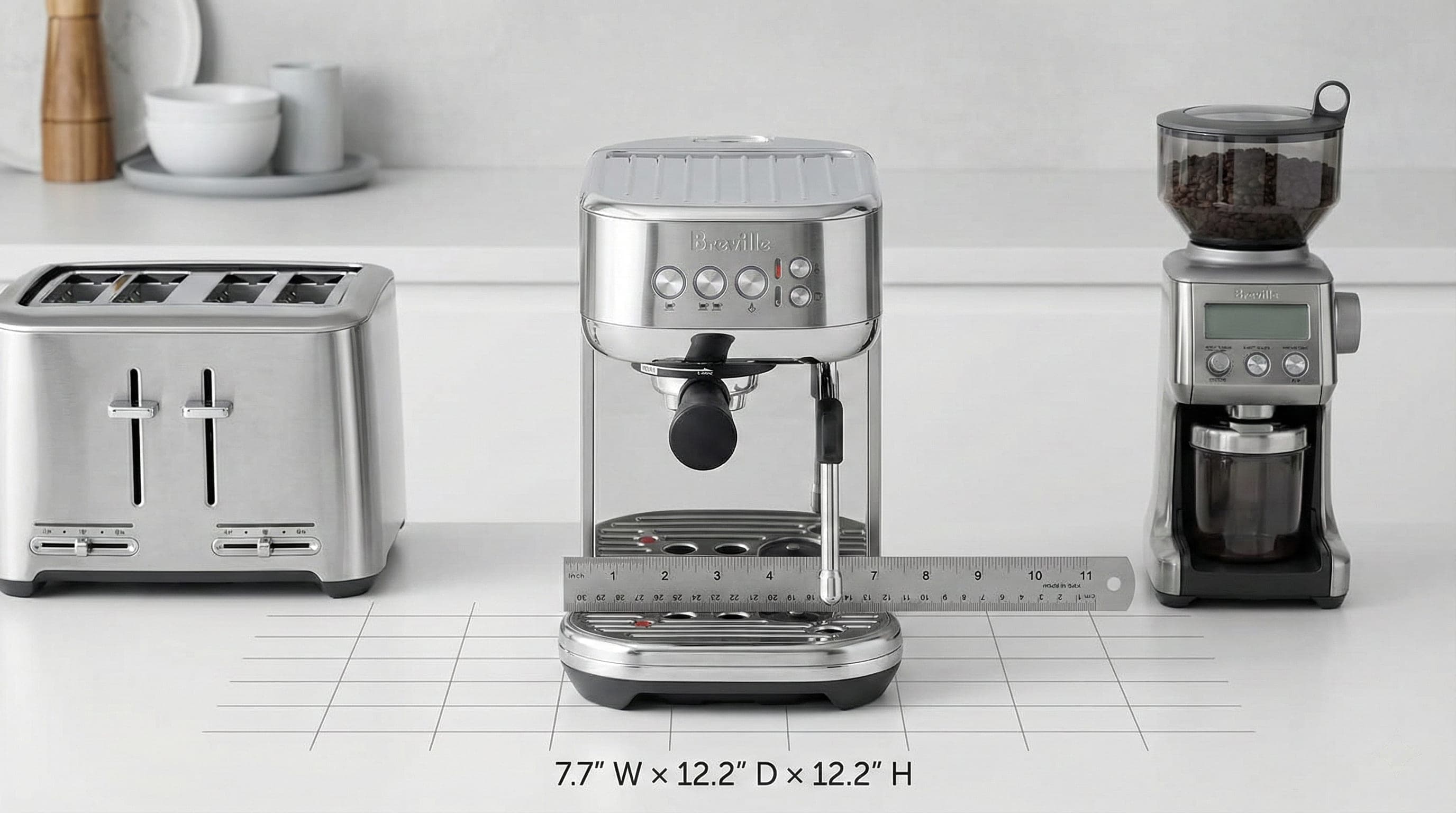 Breville Bambino Plus on a counter between a toaster and a grinder, with a ruler showing 7.7 inches wide