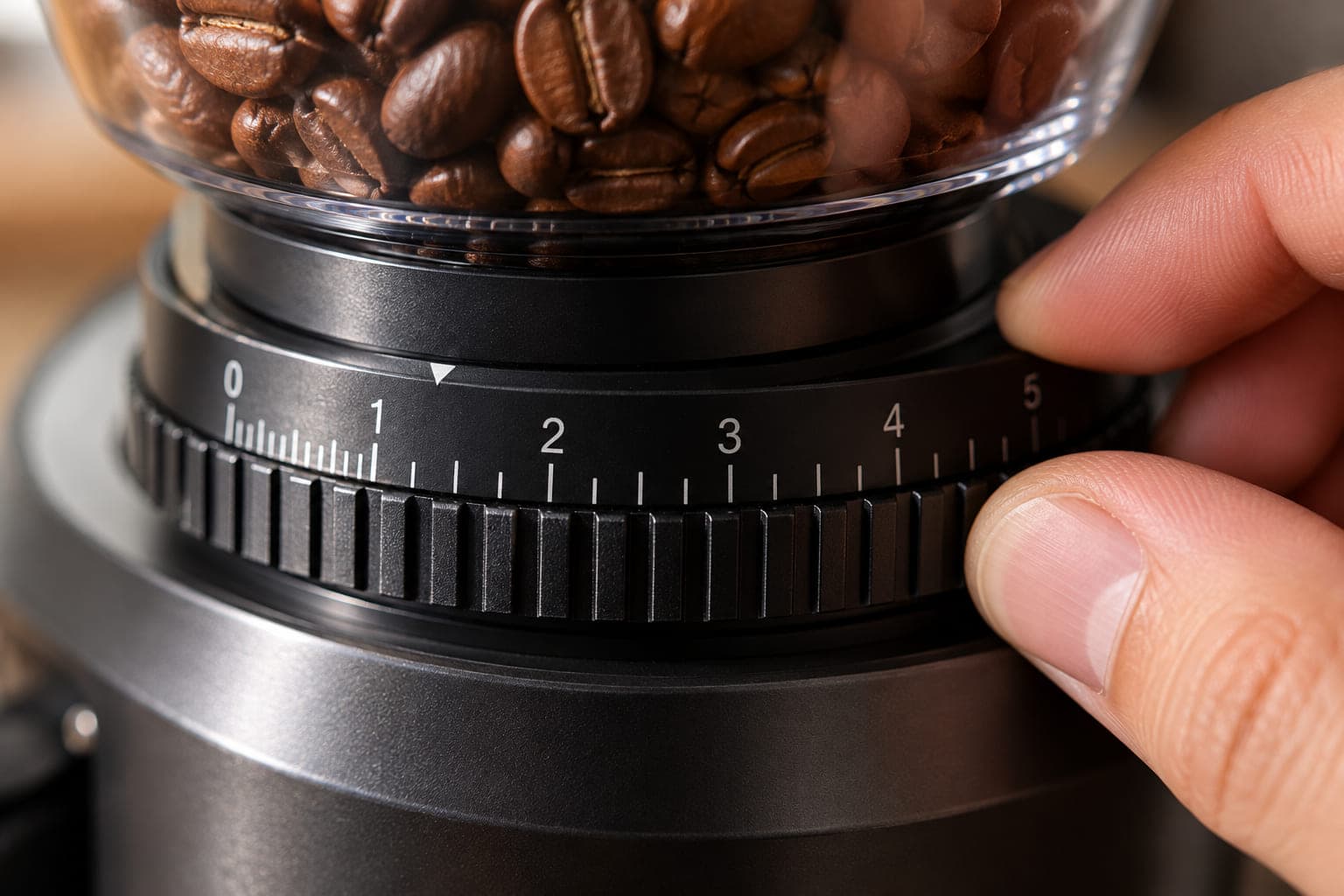 Close-up of a burr grinder's numbered adjustment collar with fine markings in the espresso range