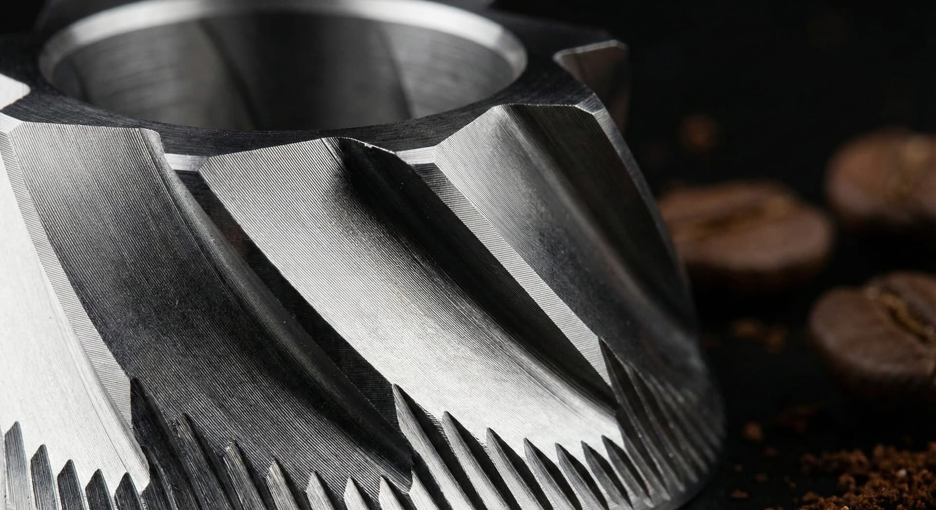 Macro close-up photograph of precision-engineered hardened stainless steel burr set showing intricate cutting teeth geometry, knife-edge patterns, and wear-resistant coating from professional grinder testing demonstrating burr technology that produces optimal particle distribution for specialty coffee extraction