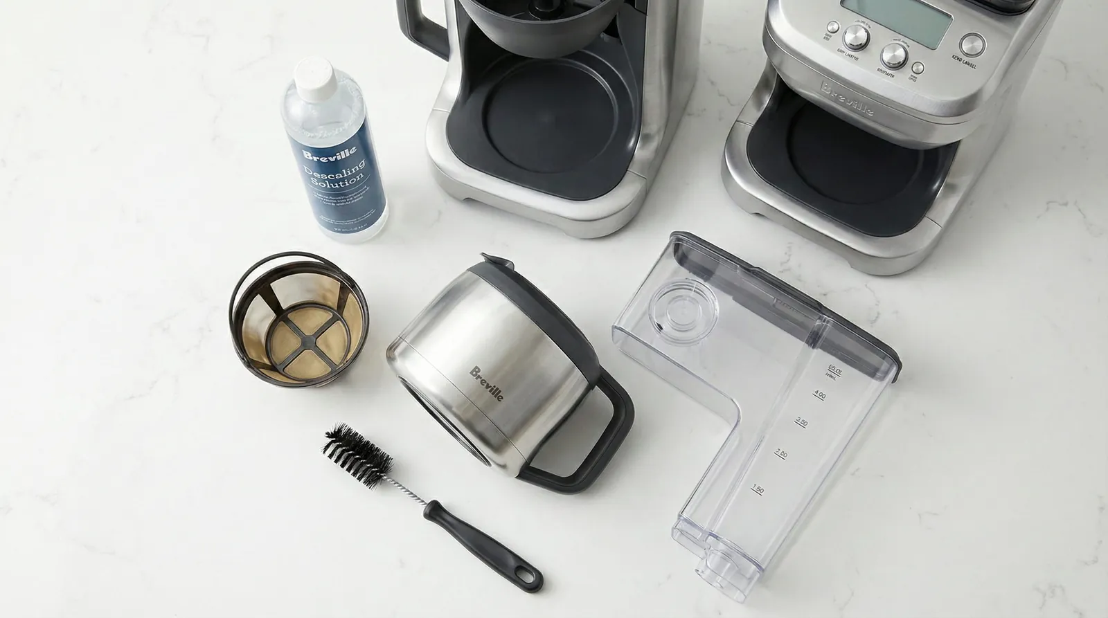 Breville Grind Control removable burr parts laid out with a cleaning brush and descaling supplies
