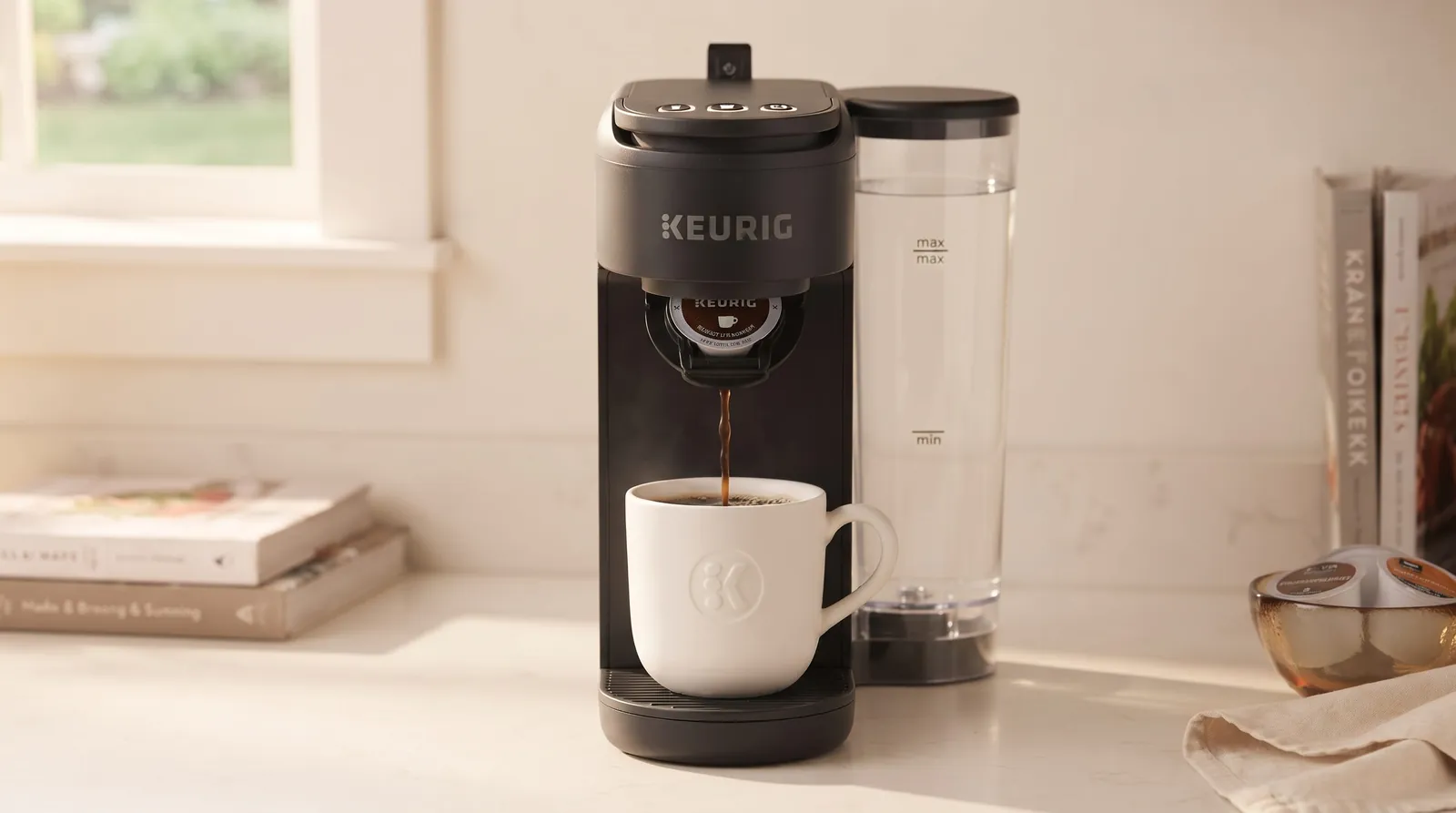 Keurig K-Mini Mate Plus seen from the front, showing the control buttons and water reservoir