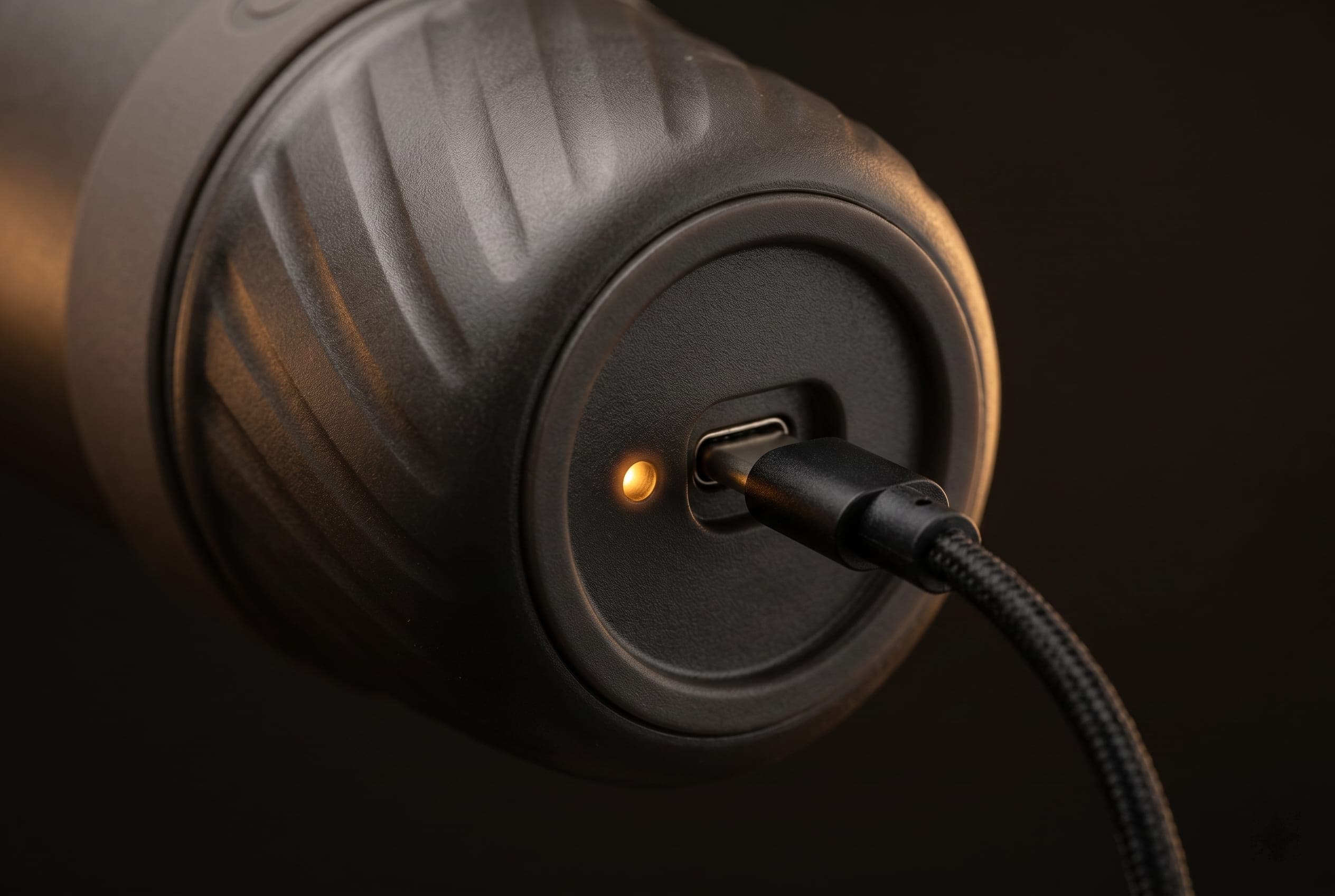 Outin Mino USB-C charging port close-up on the matte black battery-powered body