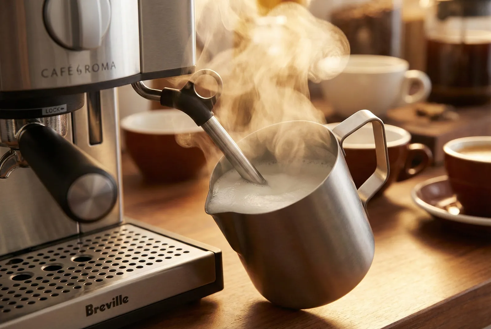 Breville ESP8XL Cafe Roma steam wand frothing milk in a small pitcher