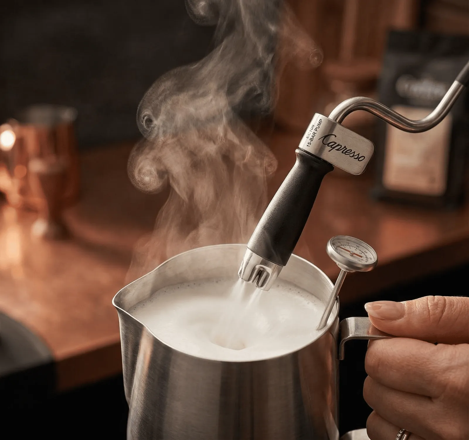 Capresso EC100 twin frother wand steaming milk in a pitcher for a cappuccino