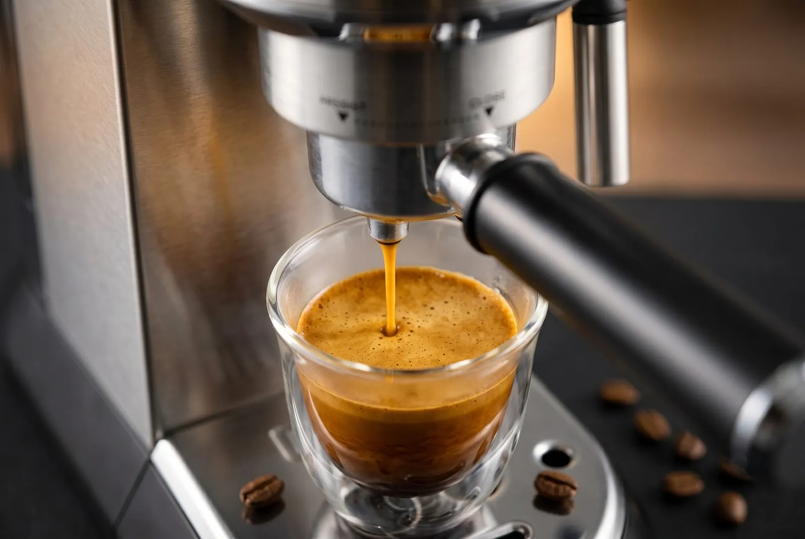 De'Longhi Dedica EC680M extracting espresso from a 51mm portafilter with crema forming in the cup