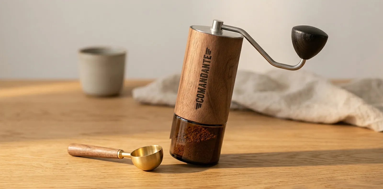 Comandante C40 walnut body and clear glass catch jar in a material close-up