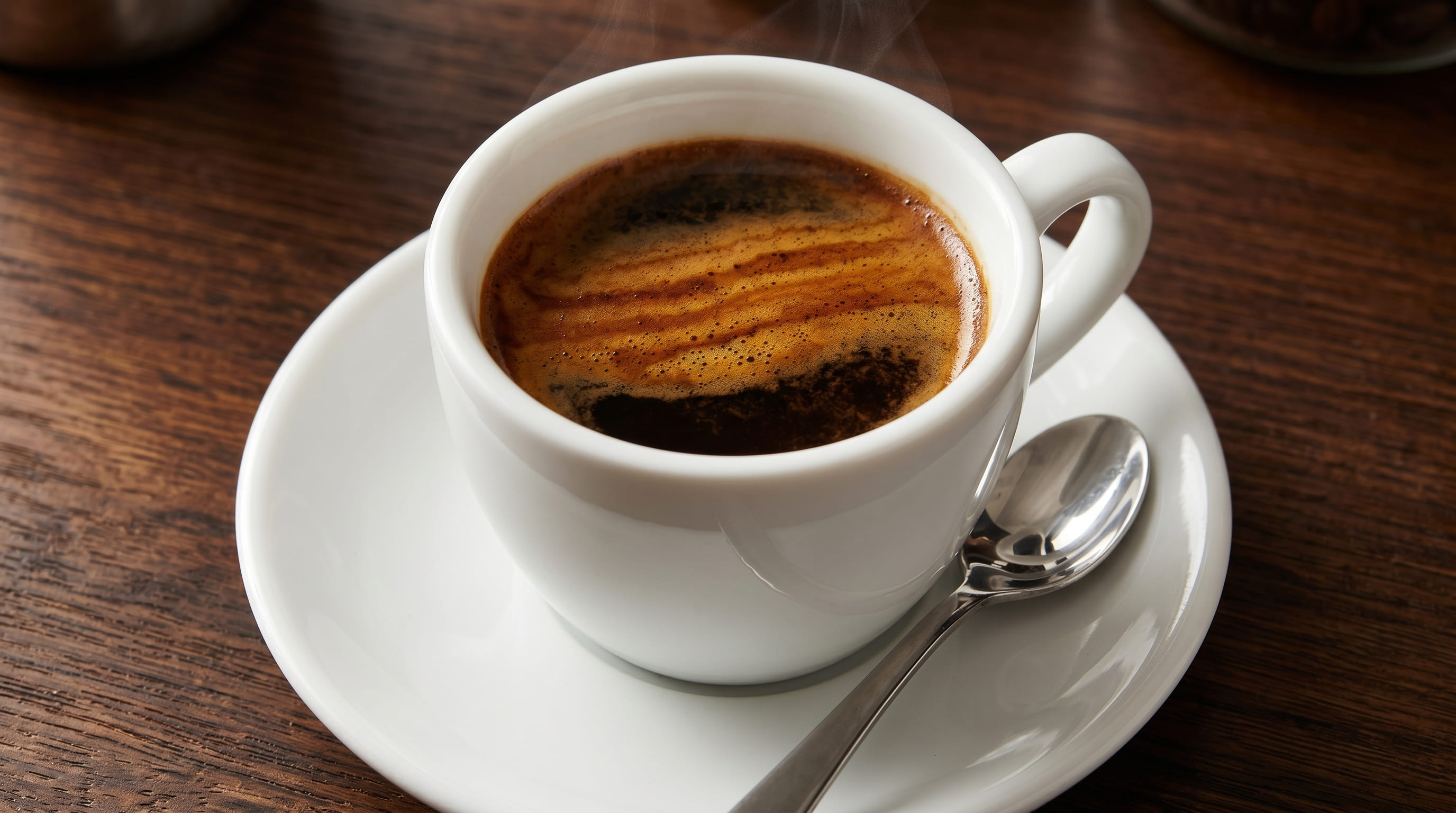 Dense espresso shot pulled from Peet's Dark Roast showing thick crema layer in white ceramic cup