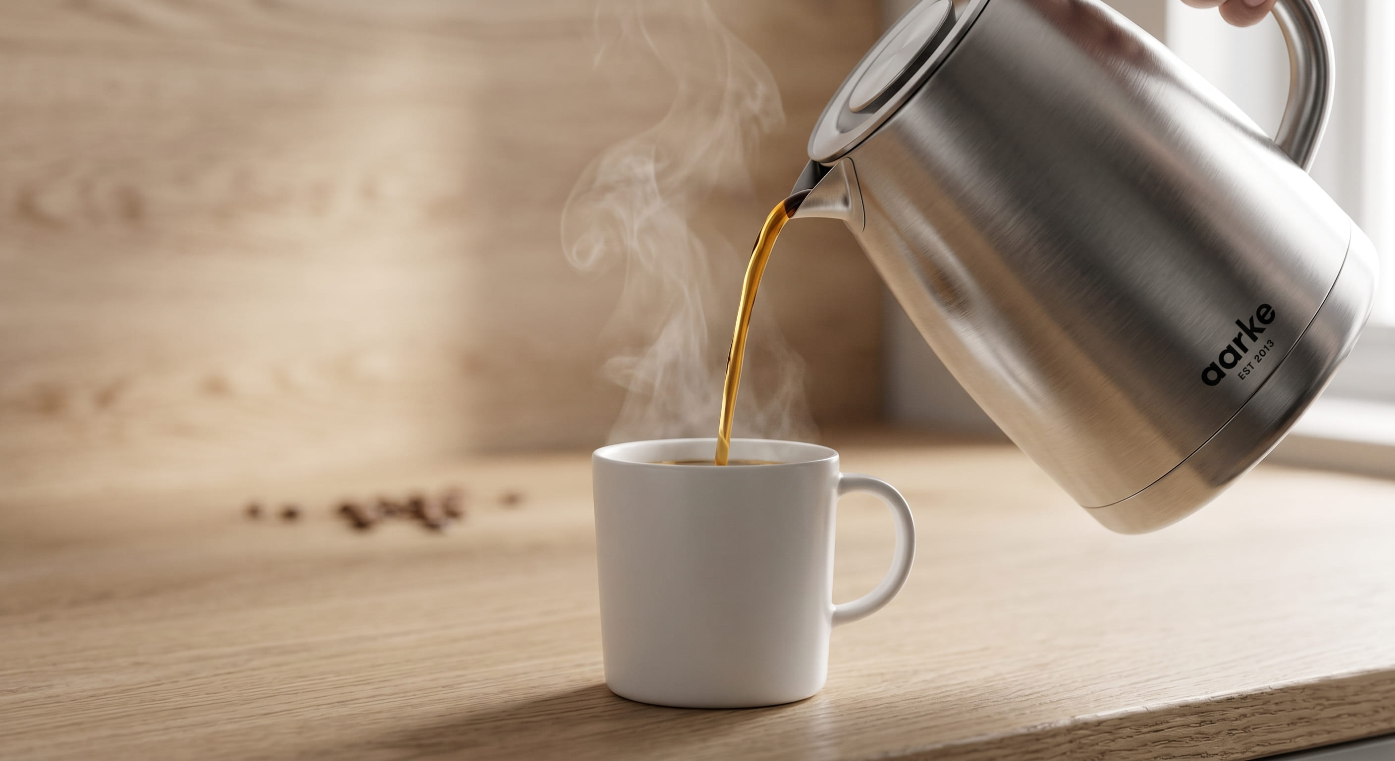 aarke coffee machine double-wall thermal stainless steel carafe pouring freshly brewed filter coffee into ceramic mug Scandinavian design