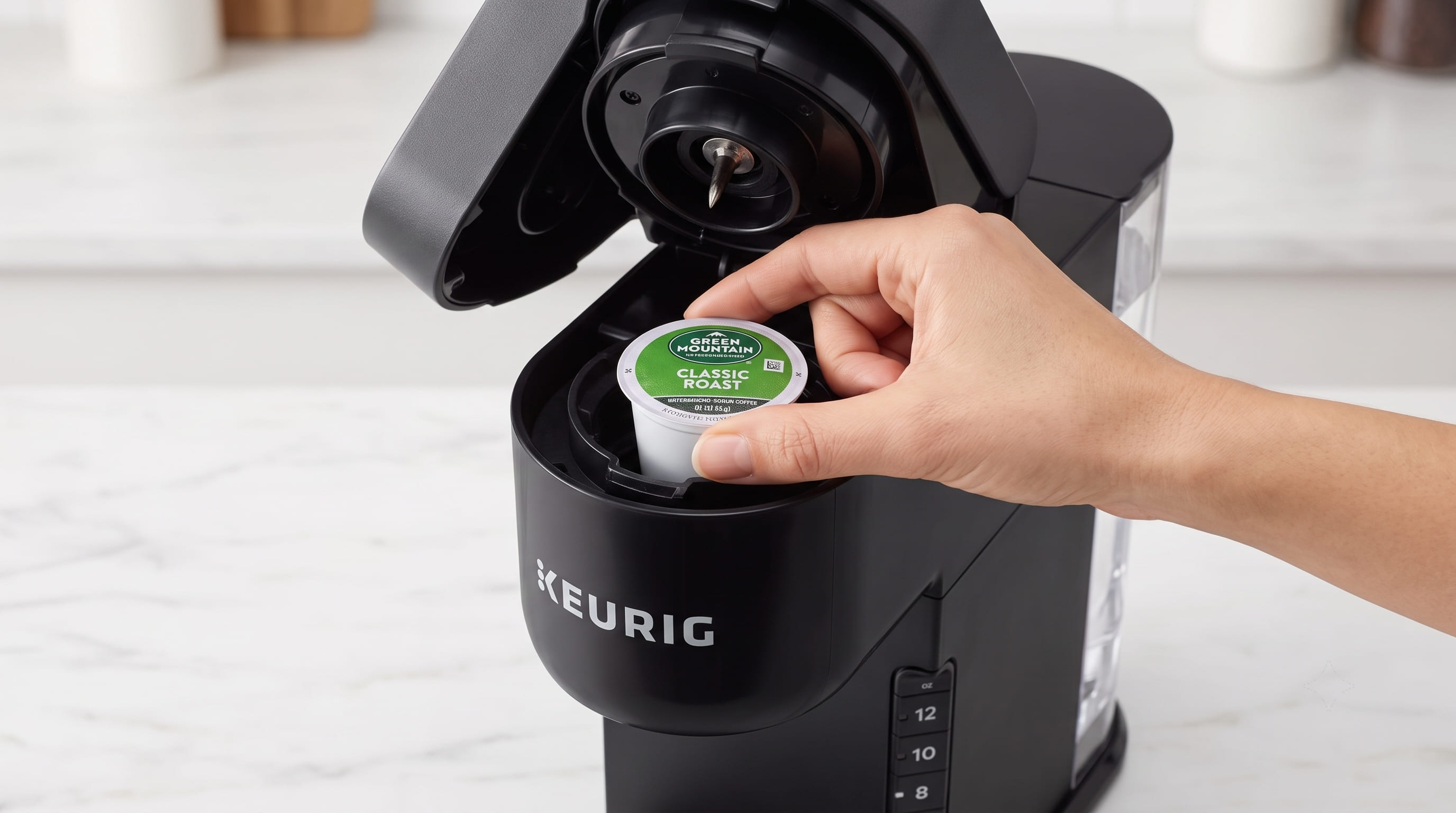 Keurig K-Express K-Cup pod being inserted into the pod holder — simple one-step pod loading process