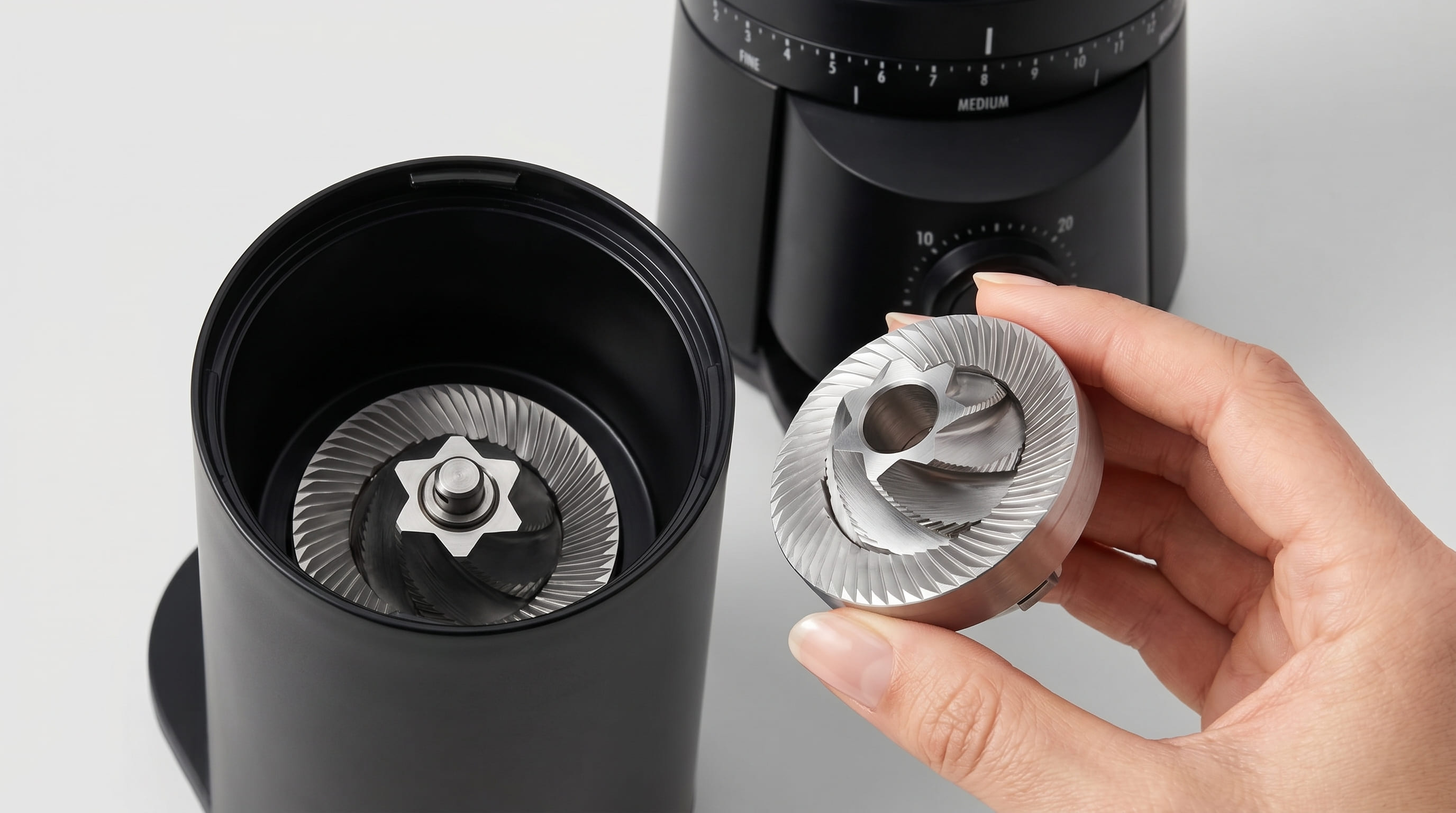 OXO Brew upper burr removed tool-free showing 40mm stainless steel conical burr teeth for cleaning